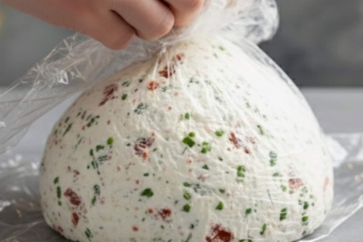 Lay a large sheet of plastic wrap on your work surface and scoop the mixture onto the center. Cover completely with a second sheet of wrap