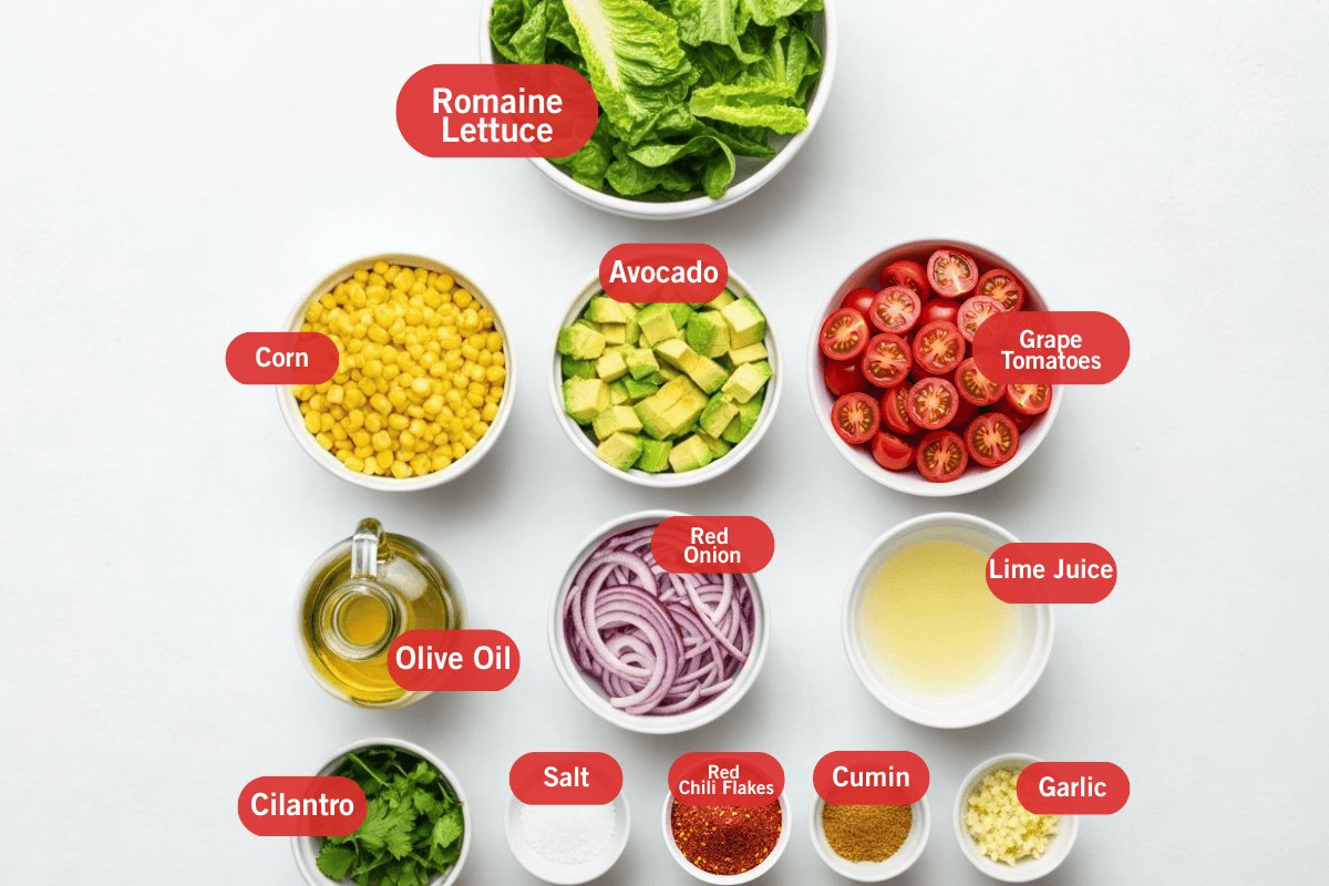 Flat lay photo of ingredient shot of romaine lettuce, corn, avocado, grape tomatoes, olive oil, red onion, lime juice, cilantro, salt, red chili flakes, cumin, garlic