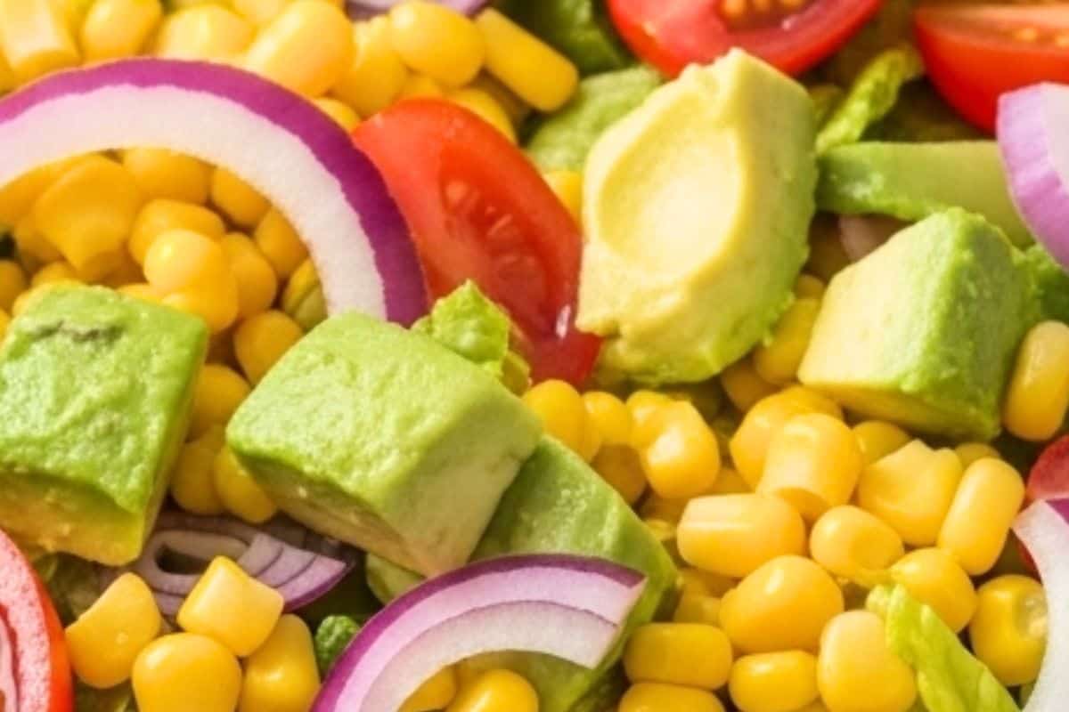 In a large bowl, combine romaine, corn, avocado, tomatoes, and red onion.