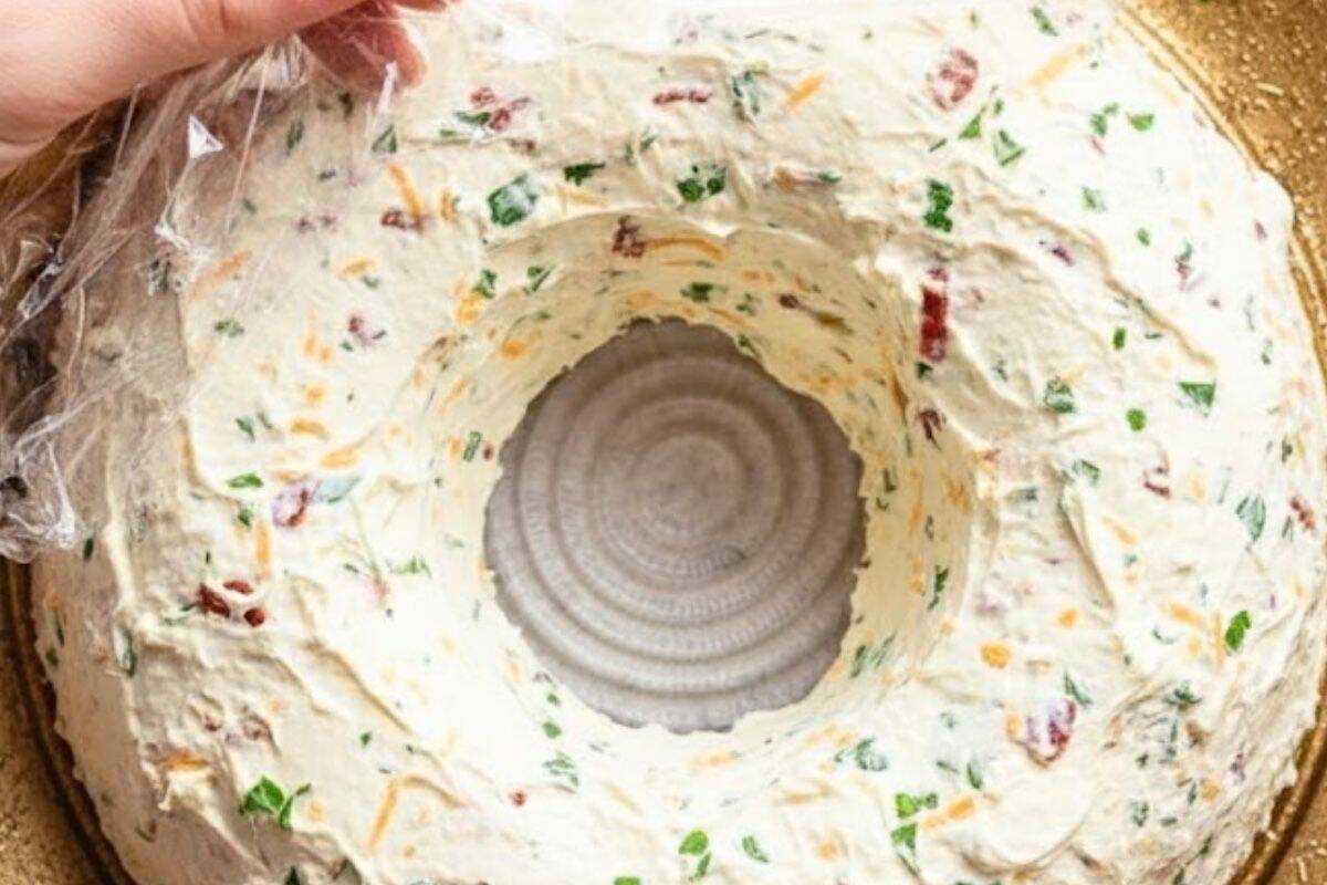 Once chilled, uncover and invert the Bacon Cheese Wreath onto a serving platter