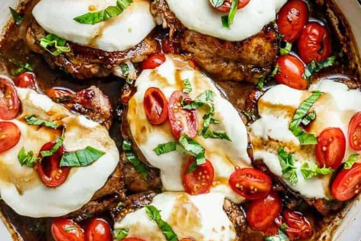Halve the remaining tomatoes and spoon them over the melted cheese, then add a little glaze from the pan and sprinkle fresh basil.
