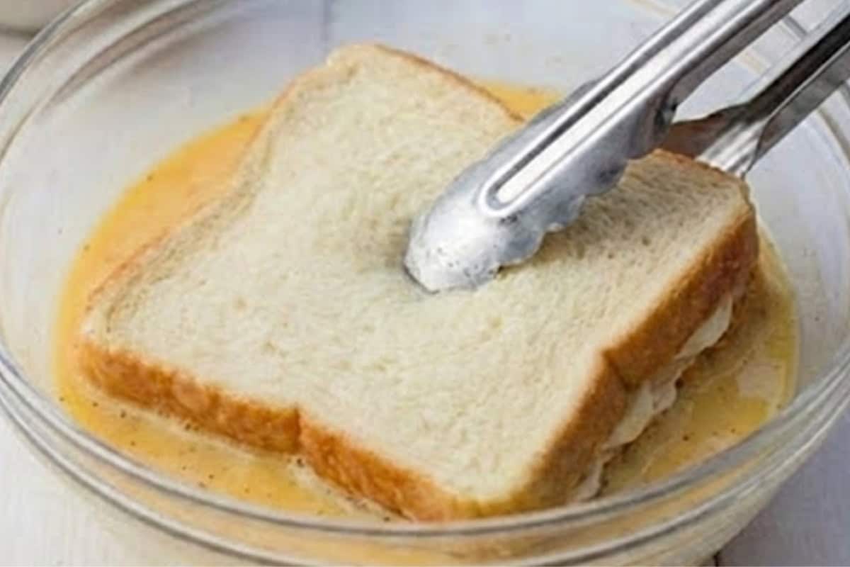 Dip the assembled sandwich into the egg mixture