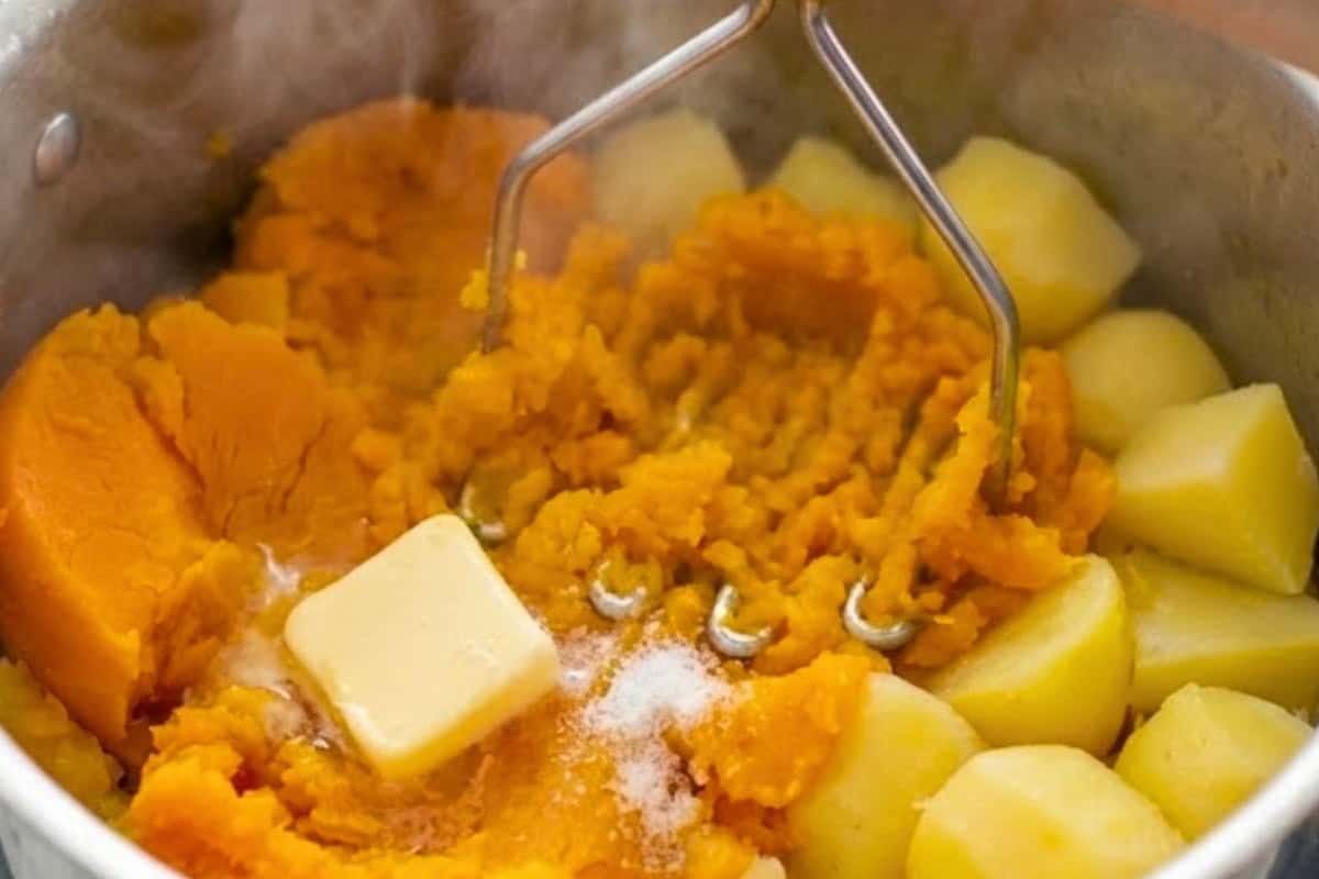 Preheat the oven to 200C | 400F and cook the pumpkin and potatoes in water until tender. Drain well, mash with butter until smooth