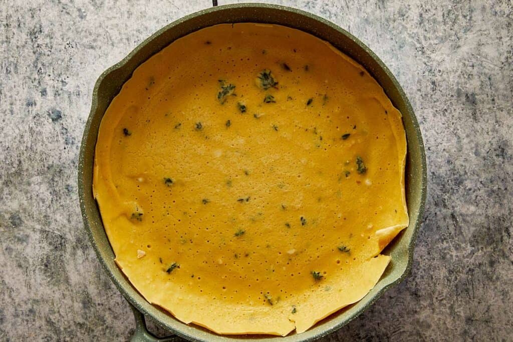 a thyme crepe in a round baking pan raw
