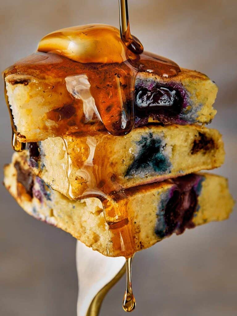 Close Up Blueberry Pancakes being hold by a fork