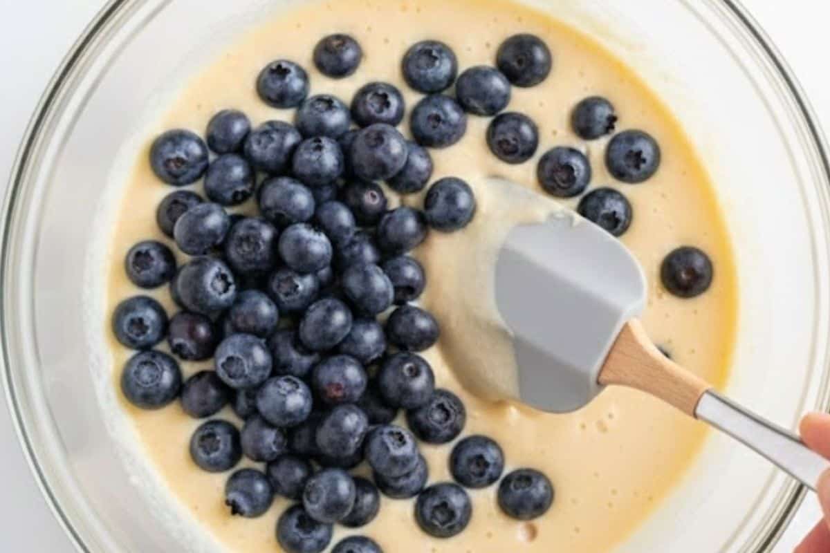 Gently fold the blueberries through the batter