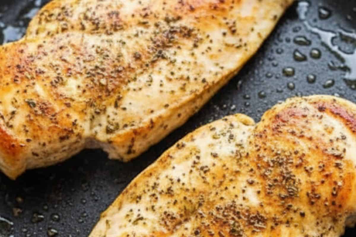 Rub chicken with basil, oregano, garlic powder, salt, and pepper. Sear in a oiled skillet.