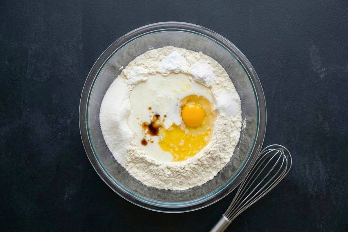 Pour in the buttermilk, slightly cooled melted butter, vanilla, and egg directly into the well