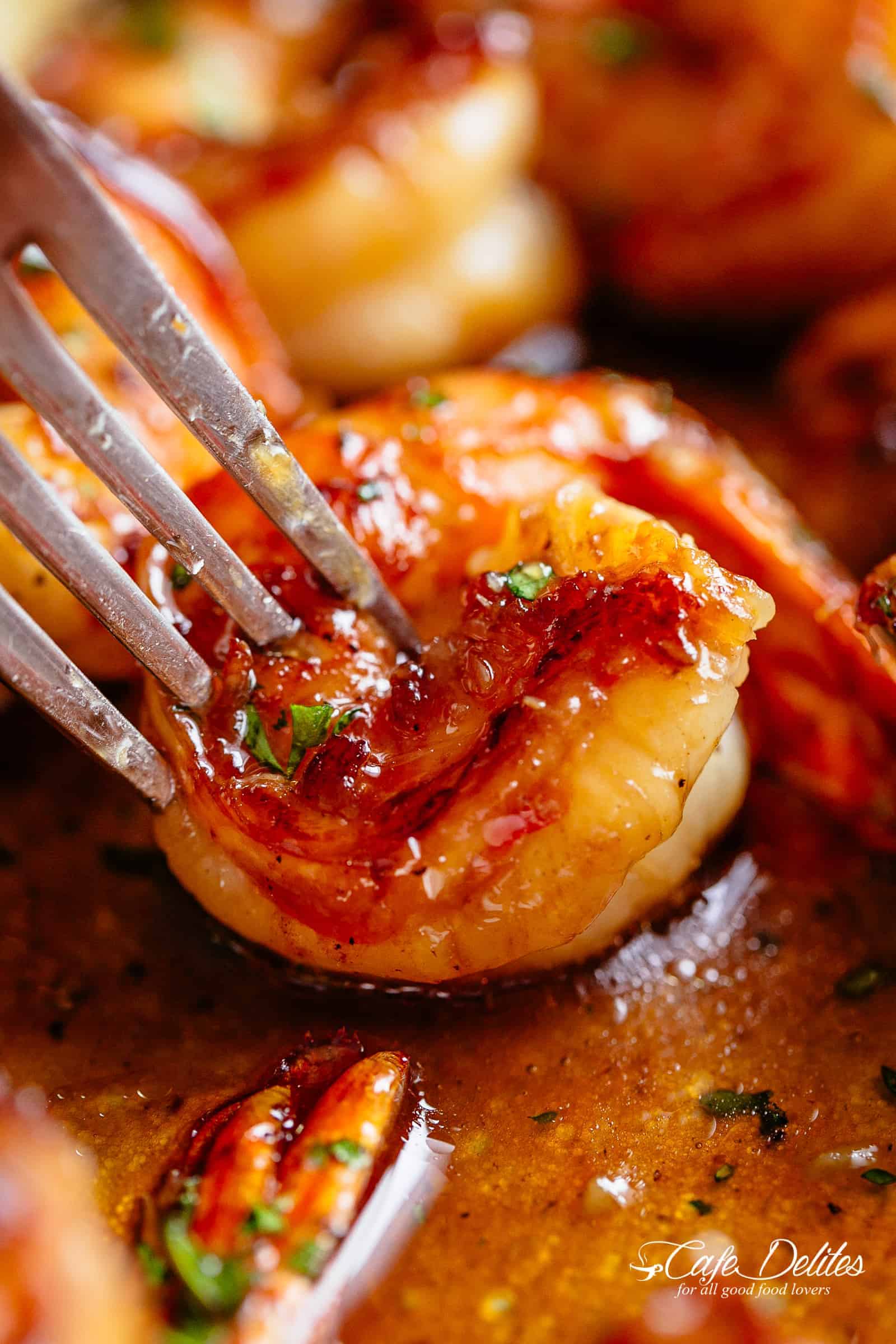 Fork pierced in Buttery Honey Garlic Shrimp