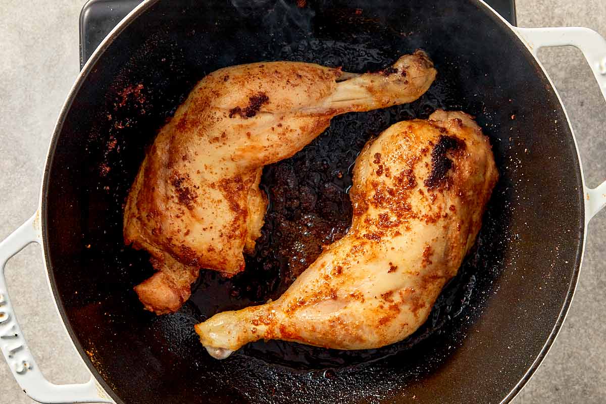 Searing seasoned chicken for cabbage chicken soup until golden to develop rich flavor
