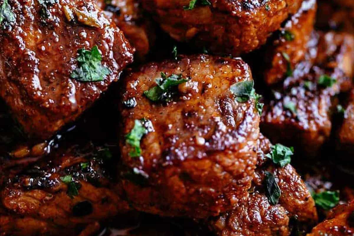 Super close, steak bites with oregano sprinkled