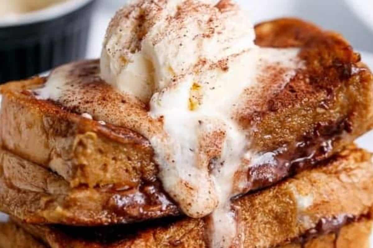 Top each Coffee French Toast with coffee cream, a scoop of ice cream if you'd like, and a sprinkle of chocolate dusting powder.
