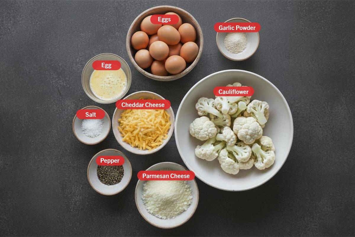 Top shot of ingredients: eggs, garlic powder, cauliflower, egg, salt, cheddar cheese, pepper, and parmesan cheese.