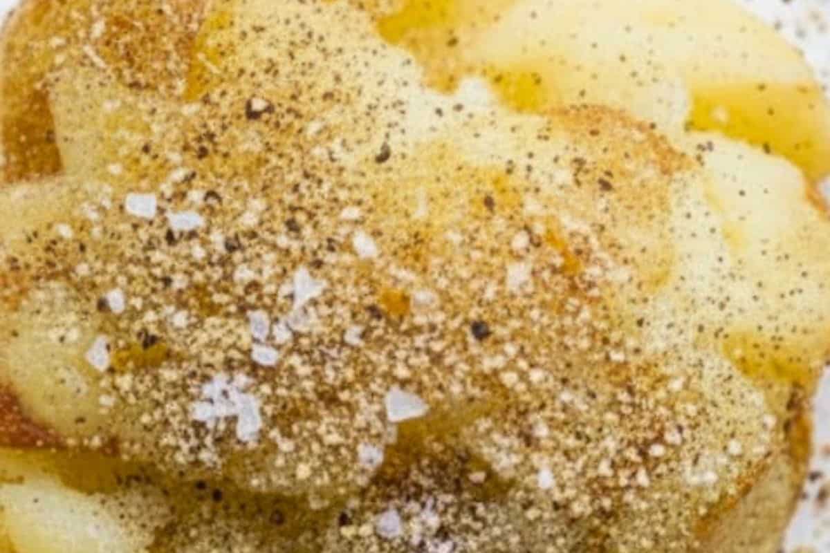 Mist the tops with olive oil spray and season each potato with salt, pepper, and garlic or onion powder.