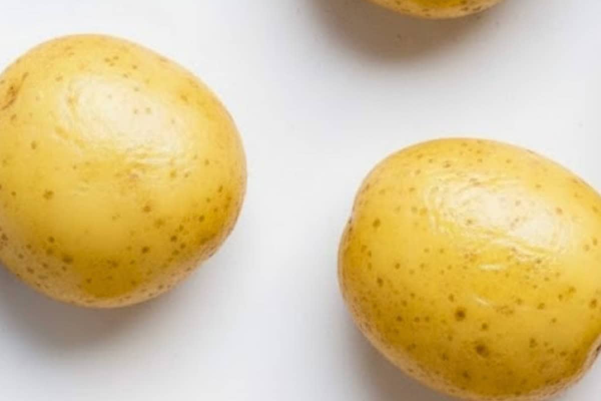Lightly grease a large baking sheet with cooking oil spray and arrange the potatoes evenly with space between each.