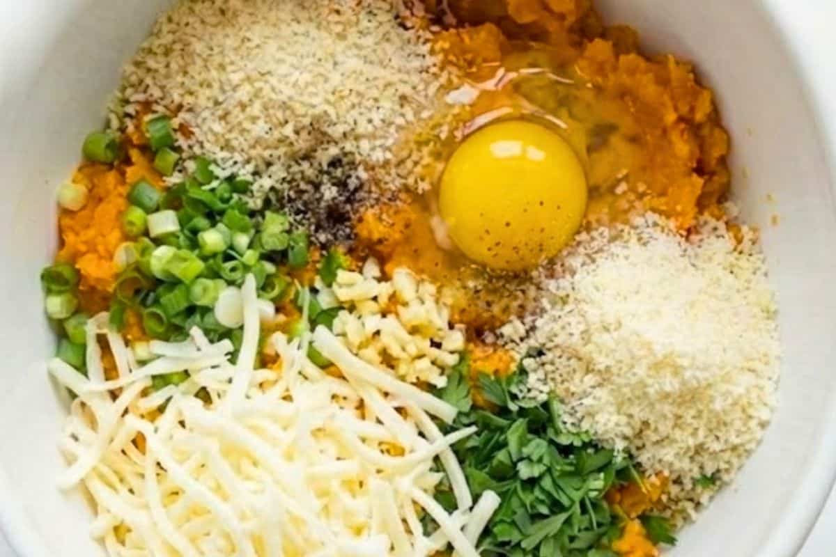 Add cheese, green onions, garlic, parsley, egg, and 1/2 cup of breadcrumbs to the sweet potatoes