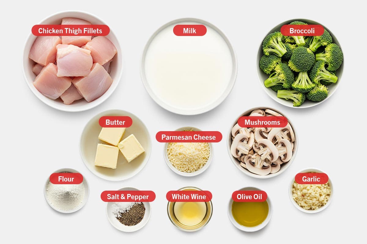 Top shot of ingredients: Chicken thigh fillets, milk, broccoli, butter, parmesan cheese, mushrooms, flour, salt and pepper, white wine, olive oil, and garlic.