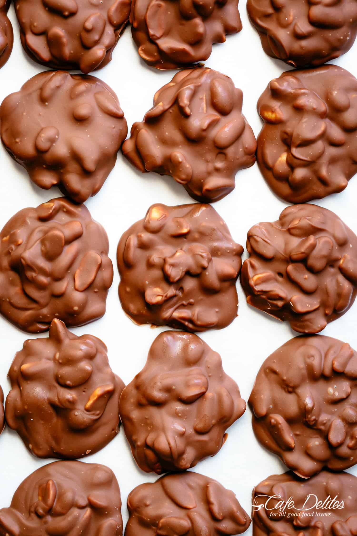 Chocolate Peanut Clusters on a baking sheet to cool down