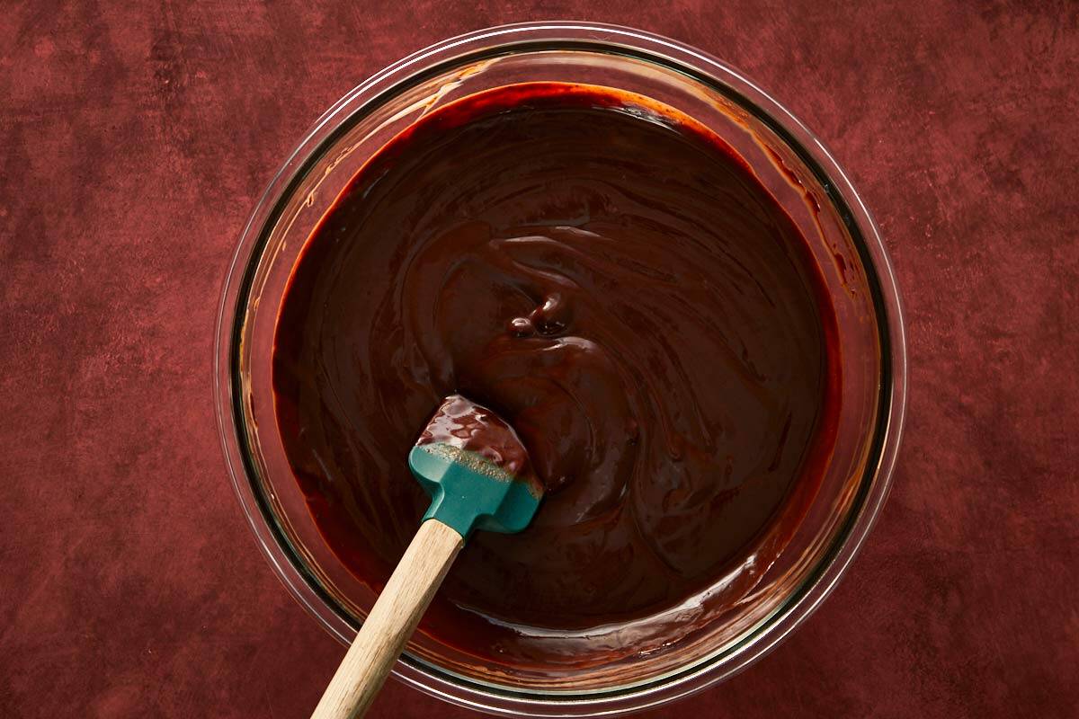 Whisking melted chocolate and cream together into a silky, rich ganache.