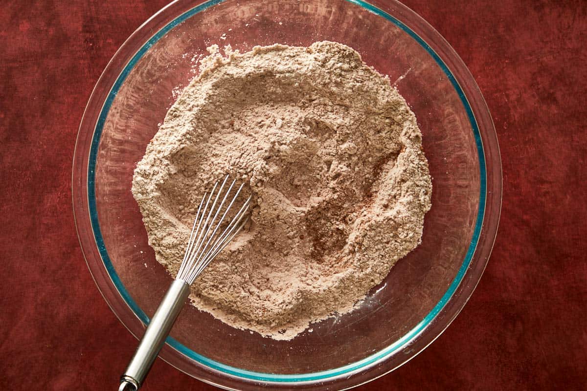 Mixing dry ingredients for cocoa chiffon cake, flour, cocoa, and sugar.