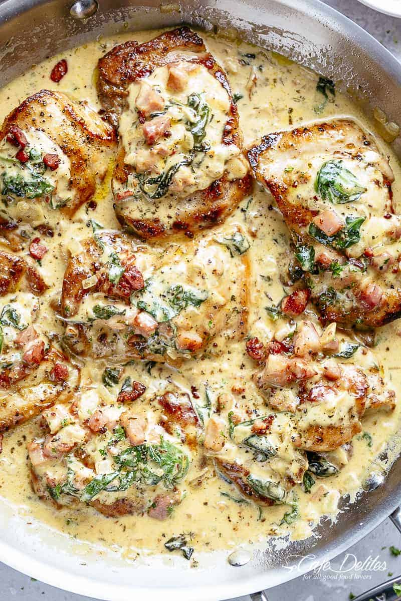 Top view of Crispy seared Chicken Thighs in a smooth and creamy garlic Dijon sauce with Bacon pieces and Spinach