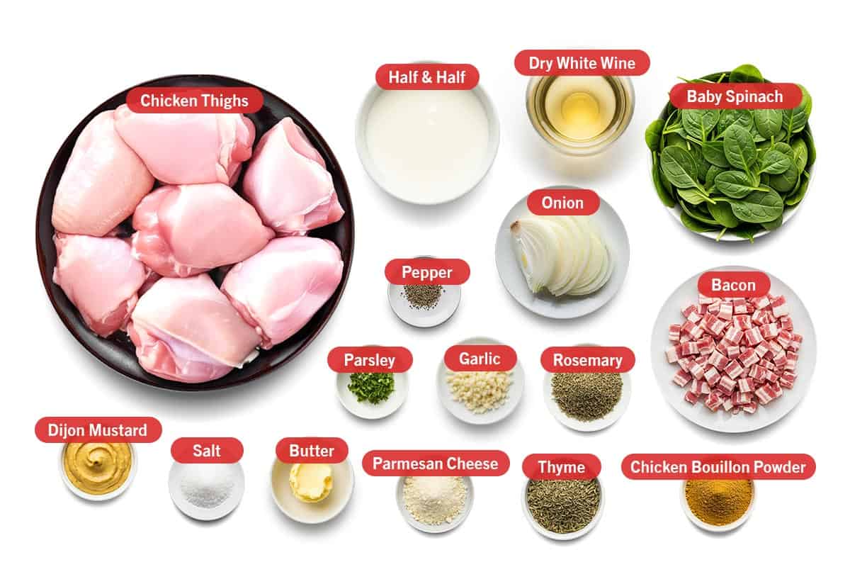 Top shot of ingredients: Chicken thighs, half & half, dry white wine, baby spinach, pepper, onion, bacon, parsley, garlic, rosemary, Dijon mustard, salt, butter, Parmesan cheese, thyme, and chicken bouillon powder.