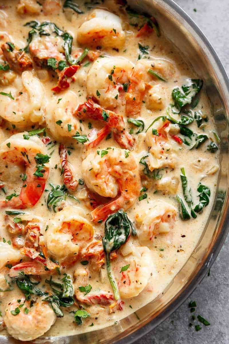Close-up image of the finished creamy garlic Tuscan butter shrimp being served.