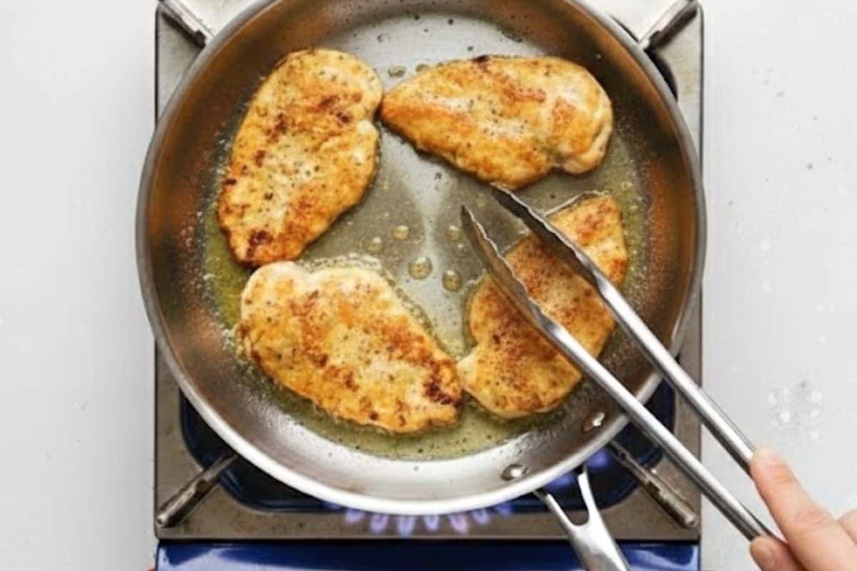 Heat oil and butter in a large skillet over medium heat and add the chicken. Fry for a few minutes on each side until they're light golden brown