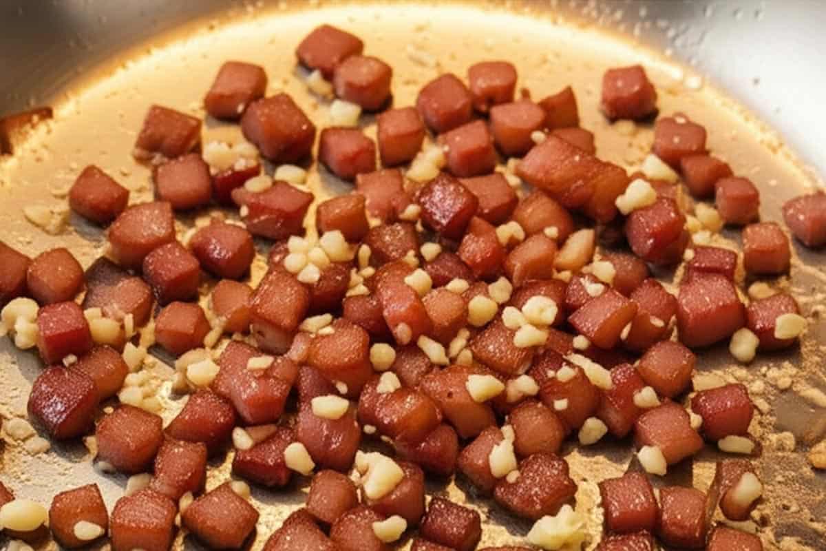 Bacon and garlic in a skillet.
