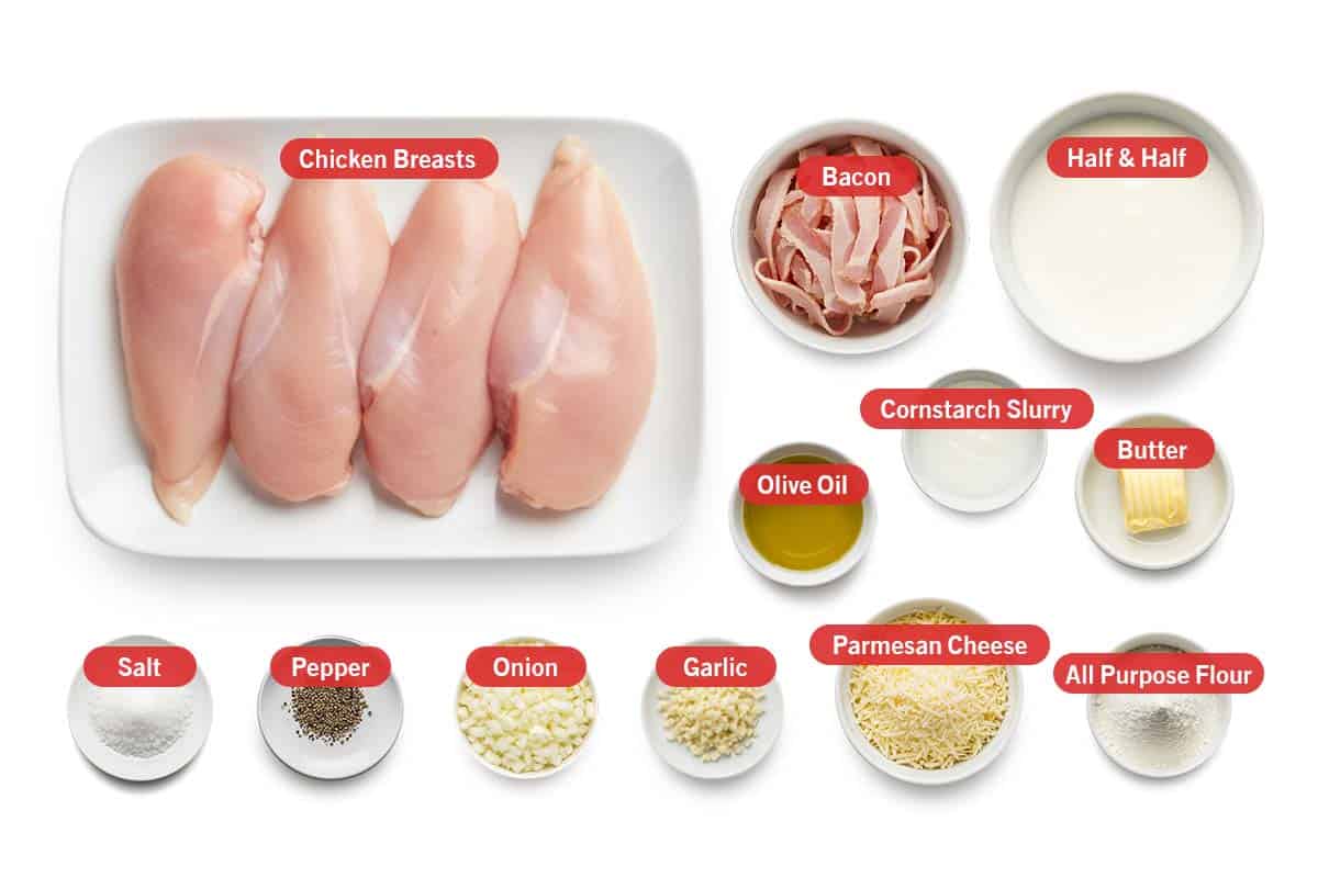 Top shot of ingredients: chicken breasts, bacon, half & half, olive oil, cornstarch slurry, butter, salt, pepper, onion, garlic, parmesan cheese, and all purpose flour.