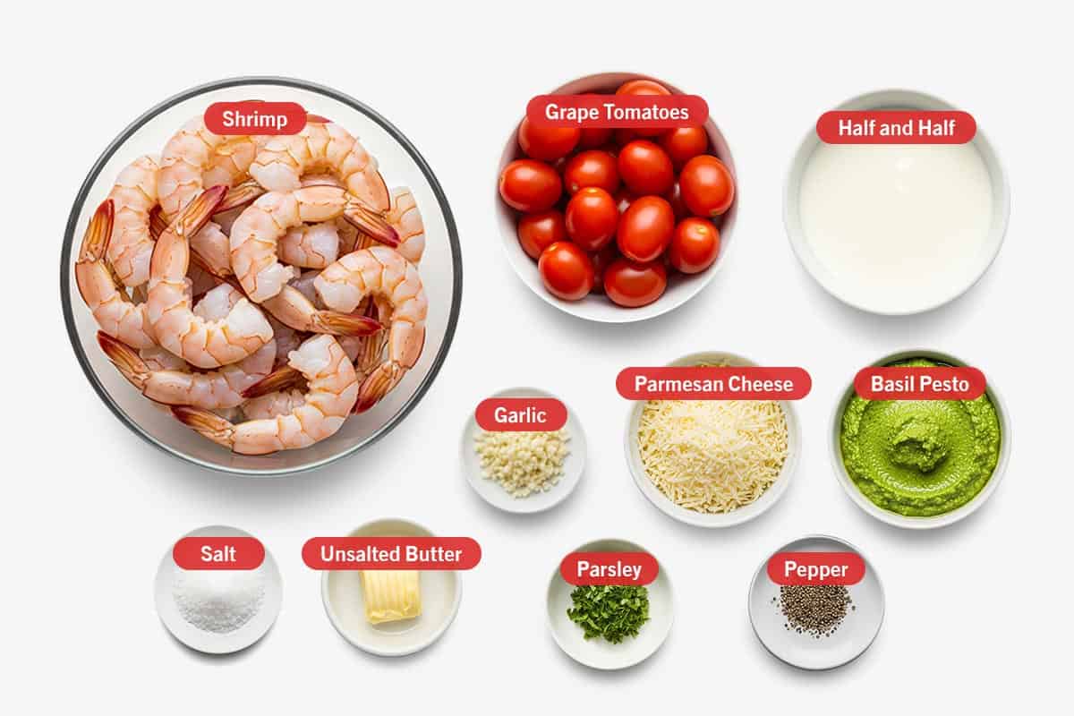 Top shot of ingredients: Shrimp, grape tomatoes, half and half, garlic, parmesan cheese, basil pesto, salt, unsalted butter, parsley, and pepper.