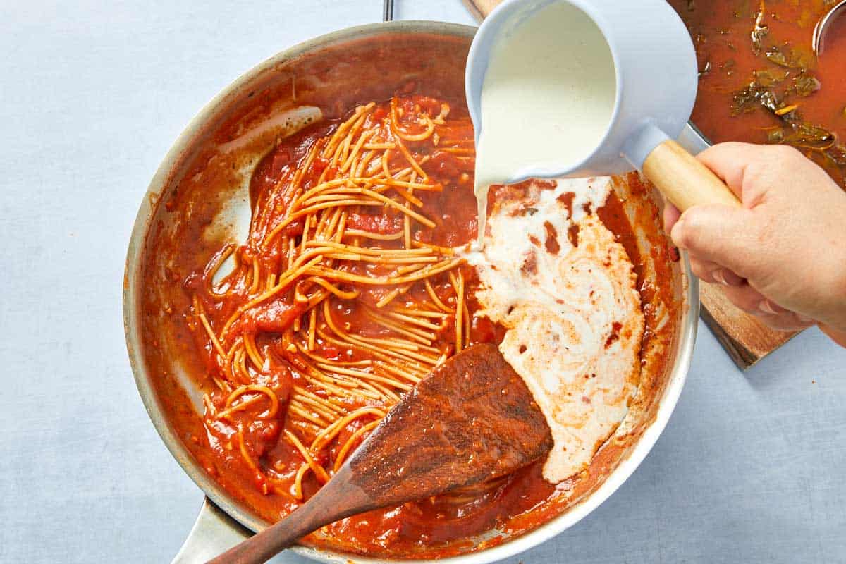 Heavy cream poured into the pasta sauce, transforming it into the signature pink.
