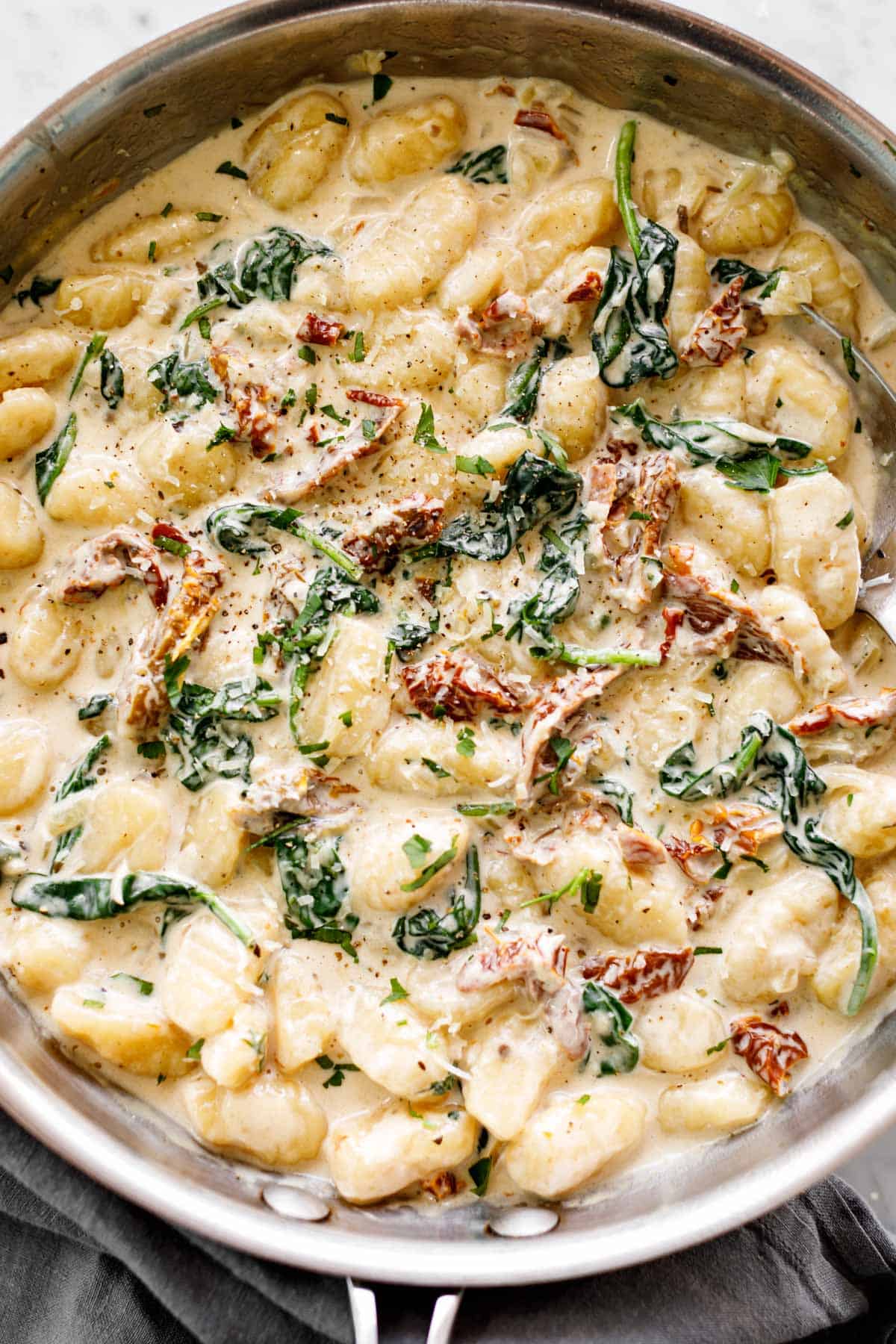 Gnocchi in a skillet with a creamy sun dried tomato sauce |