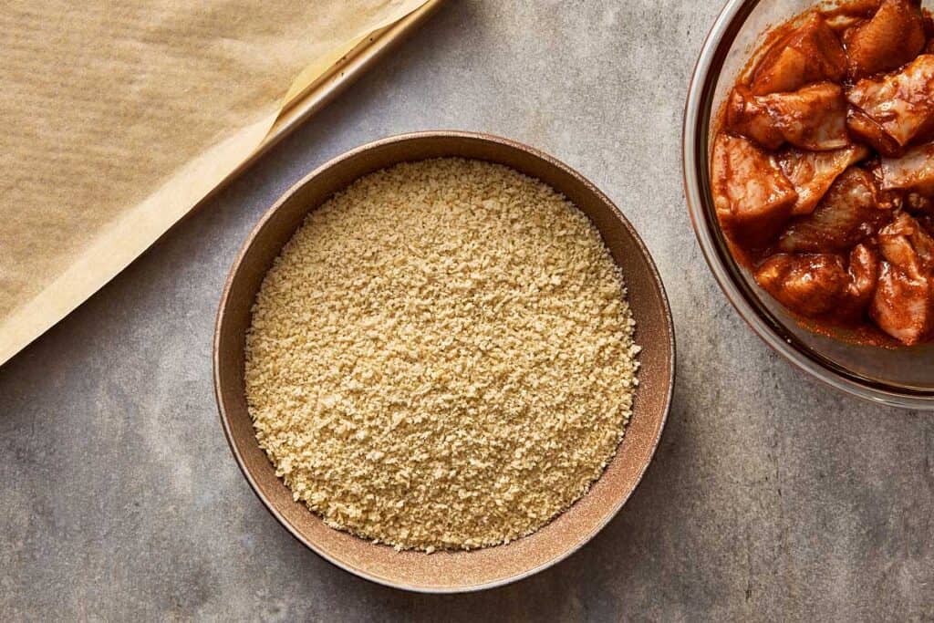 a top down view of bread crumbs in a bowl on top of a bench