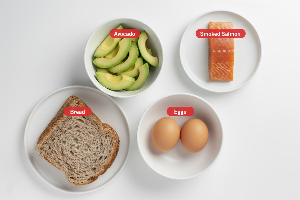 Top shot of ingredients: Avocado, bread, smoked salmon, and eggs.