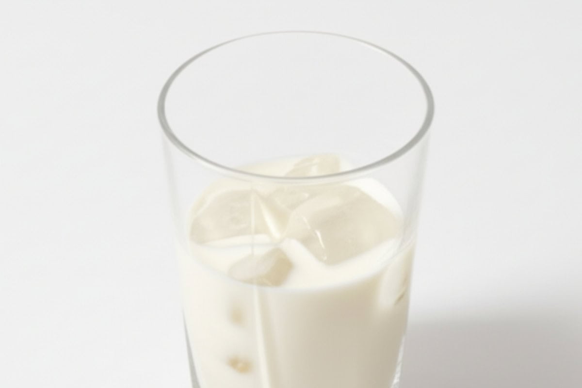 pour cold milk into the glass and add ice