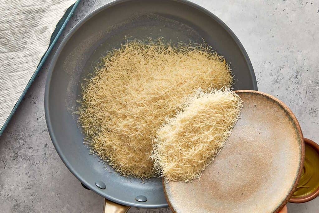 placing kadaïf into a pan toasting it top down view.