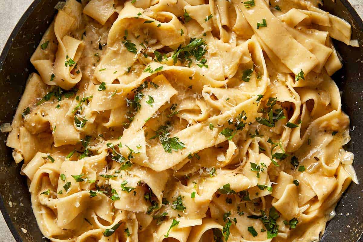 Brown butter Alfredo pasta finished with fresh parsley and grated parmesan, ready to serve.