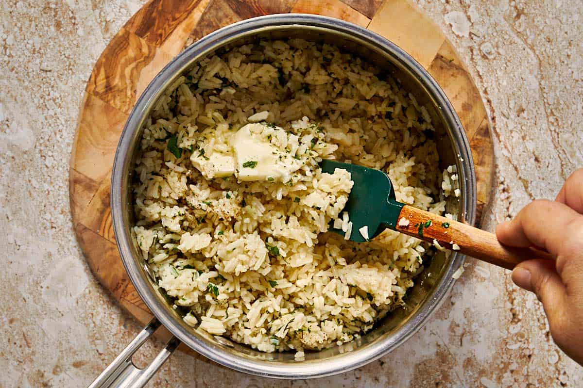 rice fully cooked in a pot with garlic butter and parsley