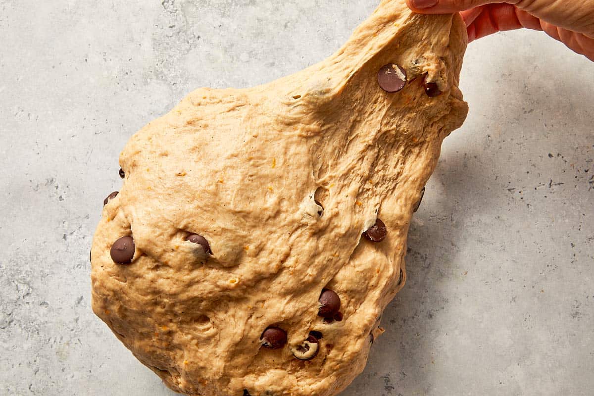 kneading dough until smooth and elastic texture forms
