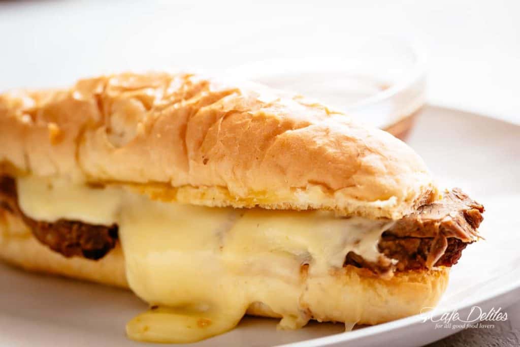 Side view of French Dip Sandwich kept on a plate