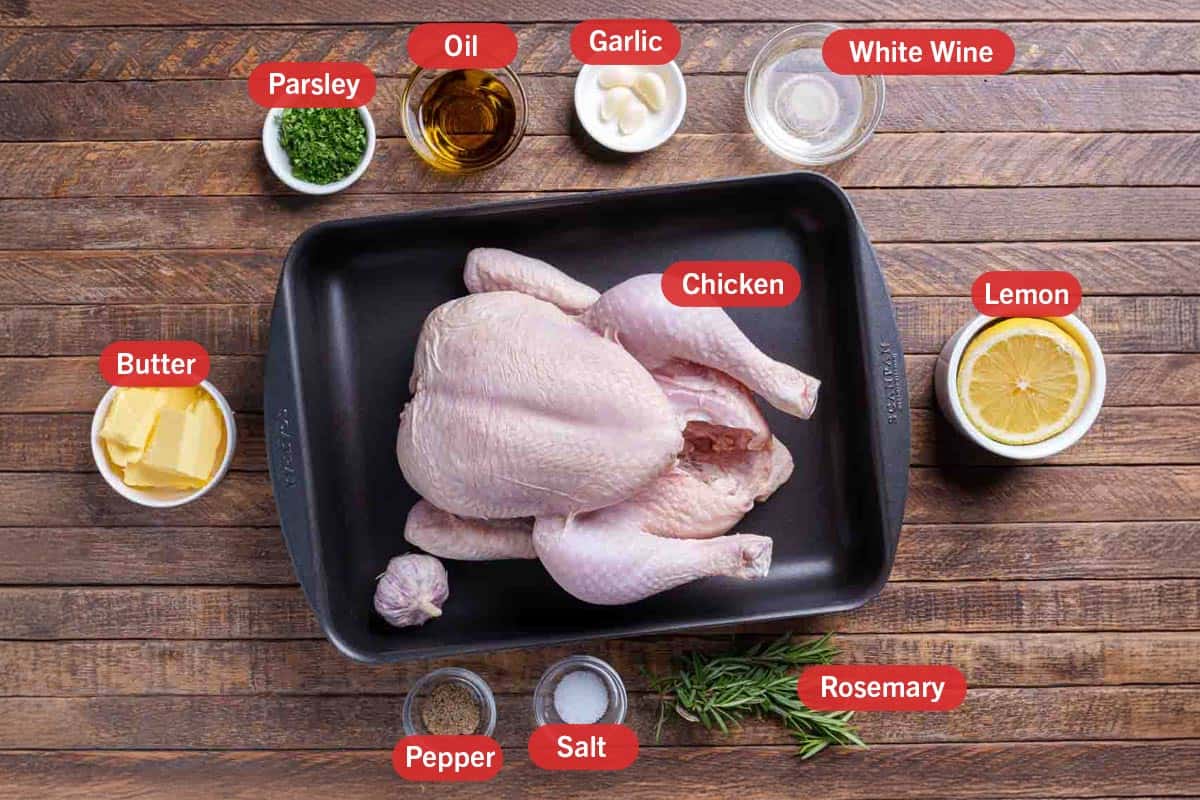 Image of the ingredients needed to prepare garlic herb roast chicken, specifically: butter, chicken, parsley, oil, garlic, white wine, lemon, rosemary, salt, and pepper.