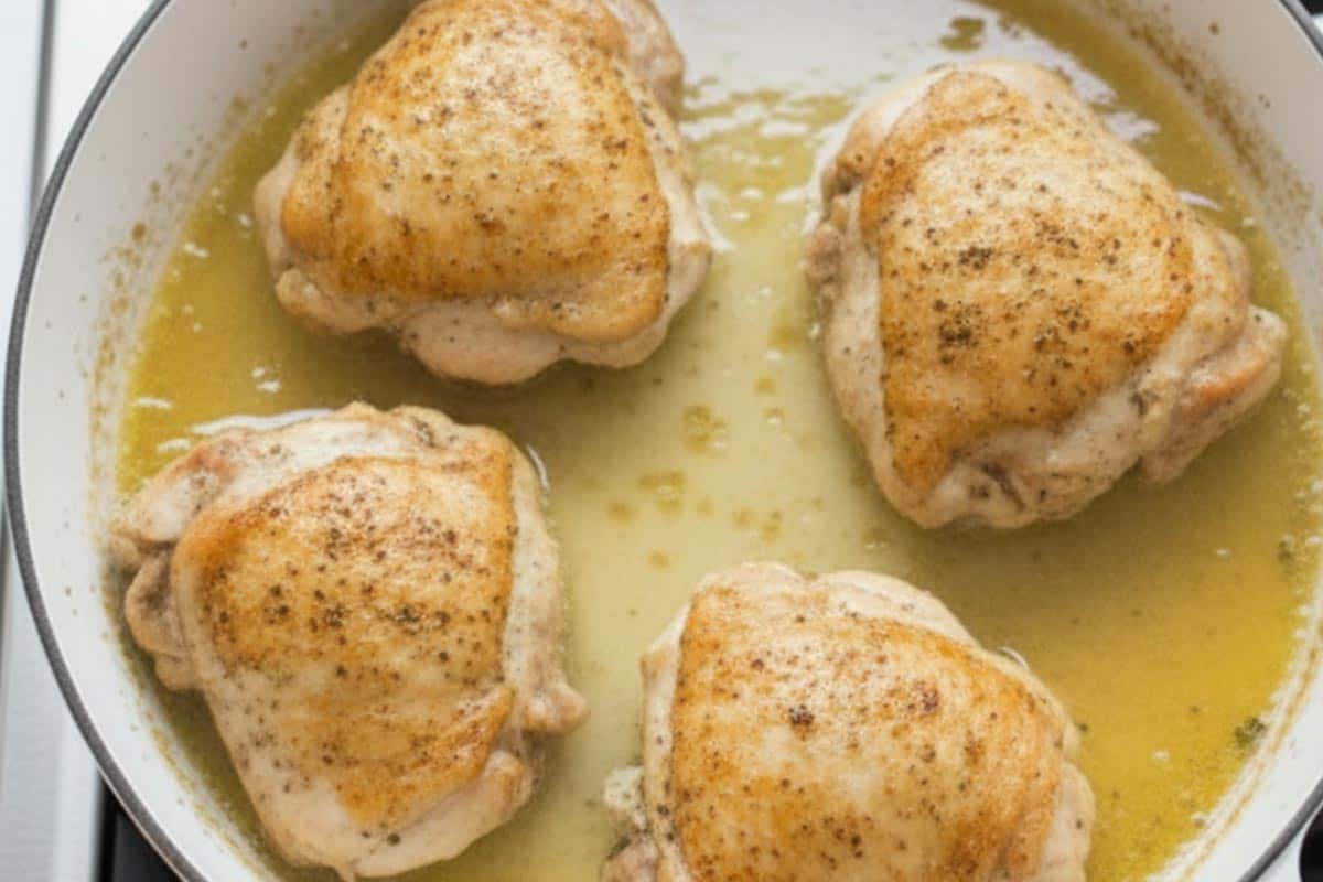 Searing the thighs until brown.