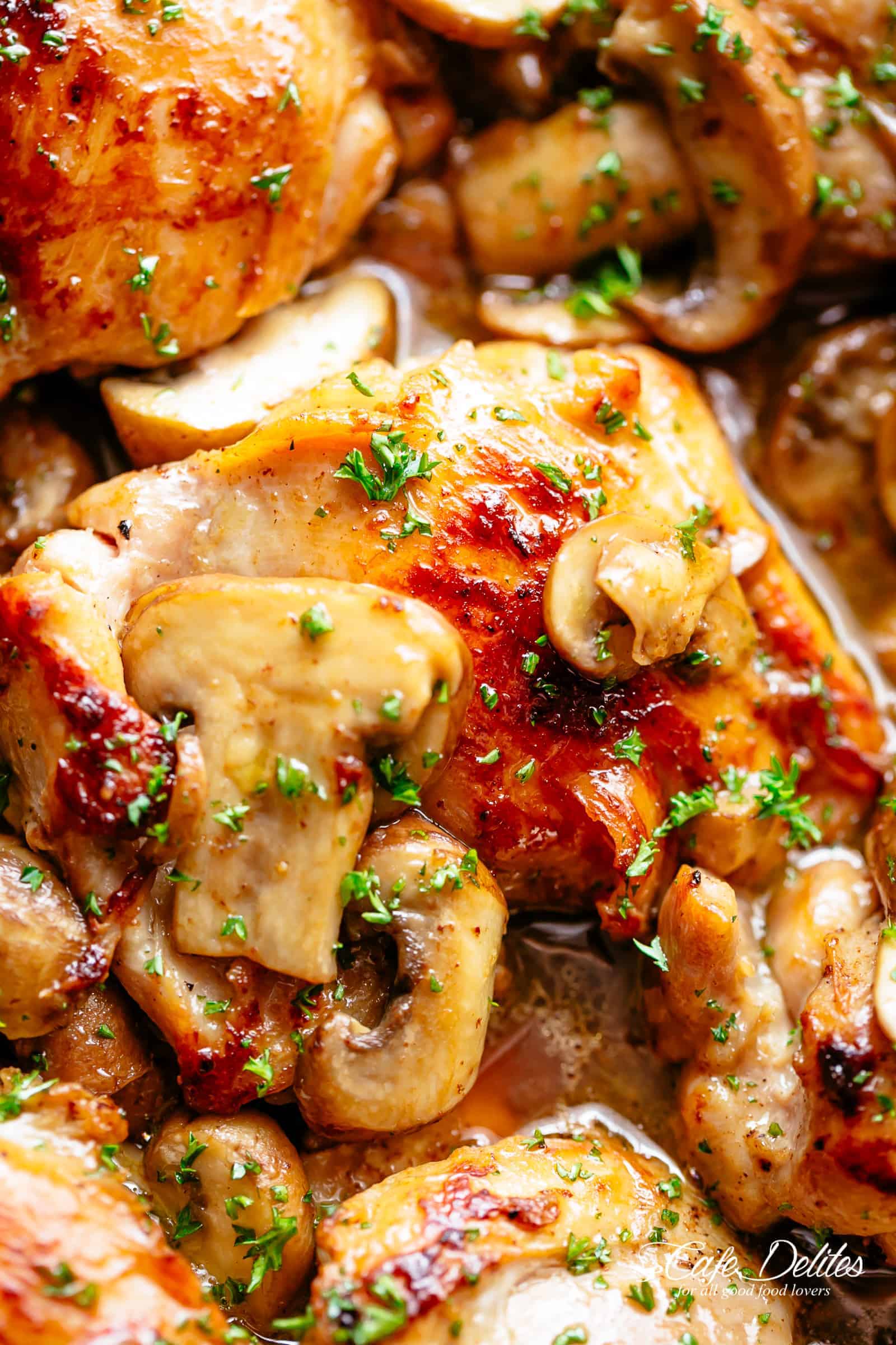 Golden seared Garlic Mushroom Chicken Thighs in a good, buttery sauce with a sprinkle of herbs