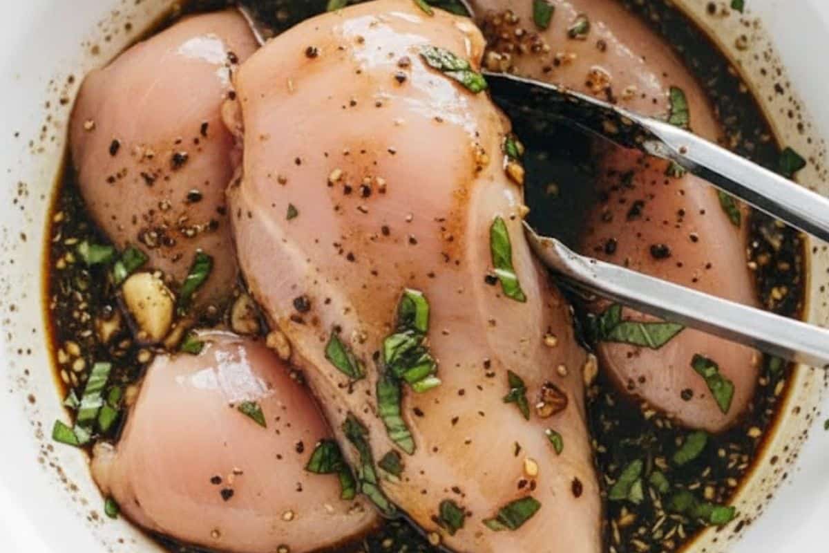 Add the chicken breasts to the bowl and coat them well.