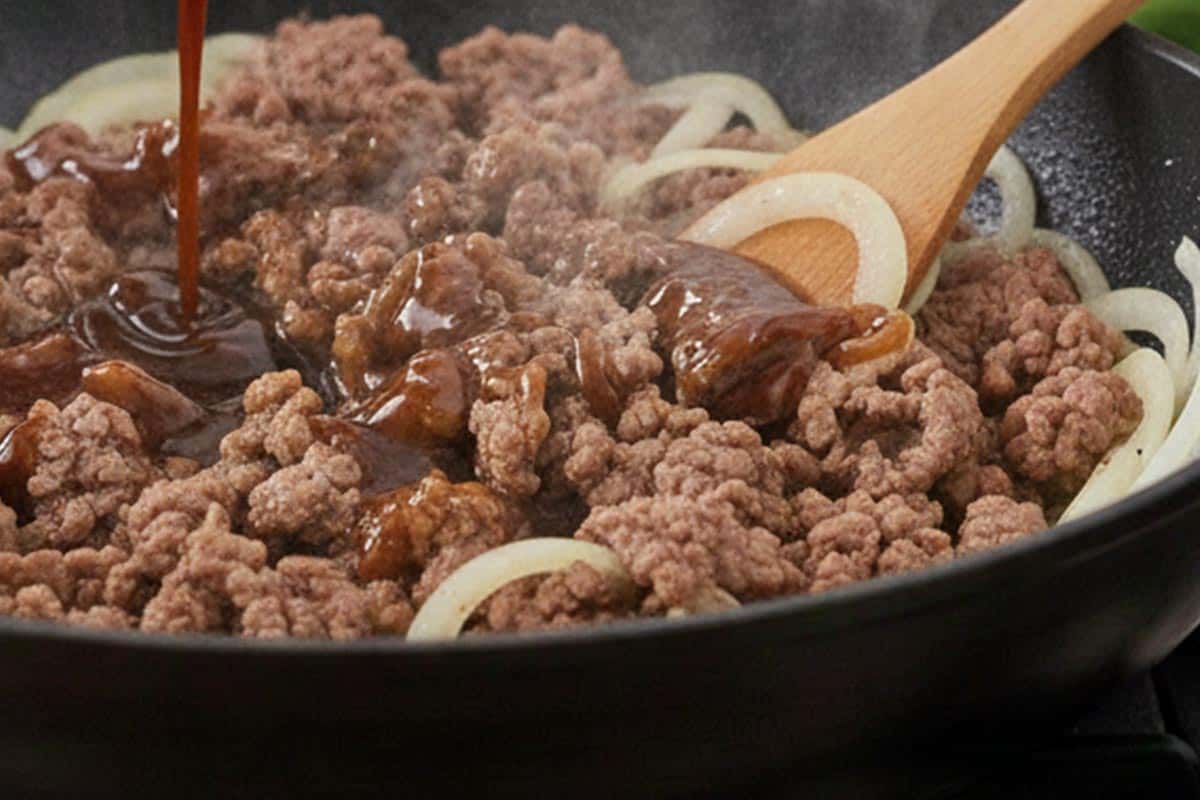 Pouring in half of the prepared sauce.