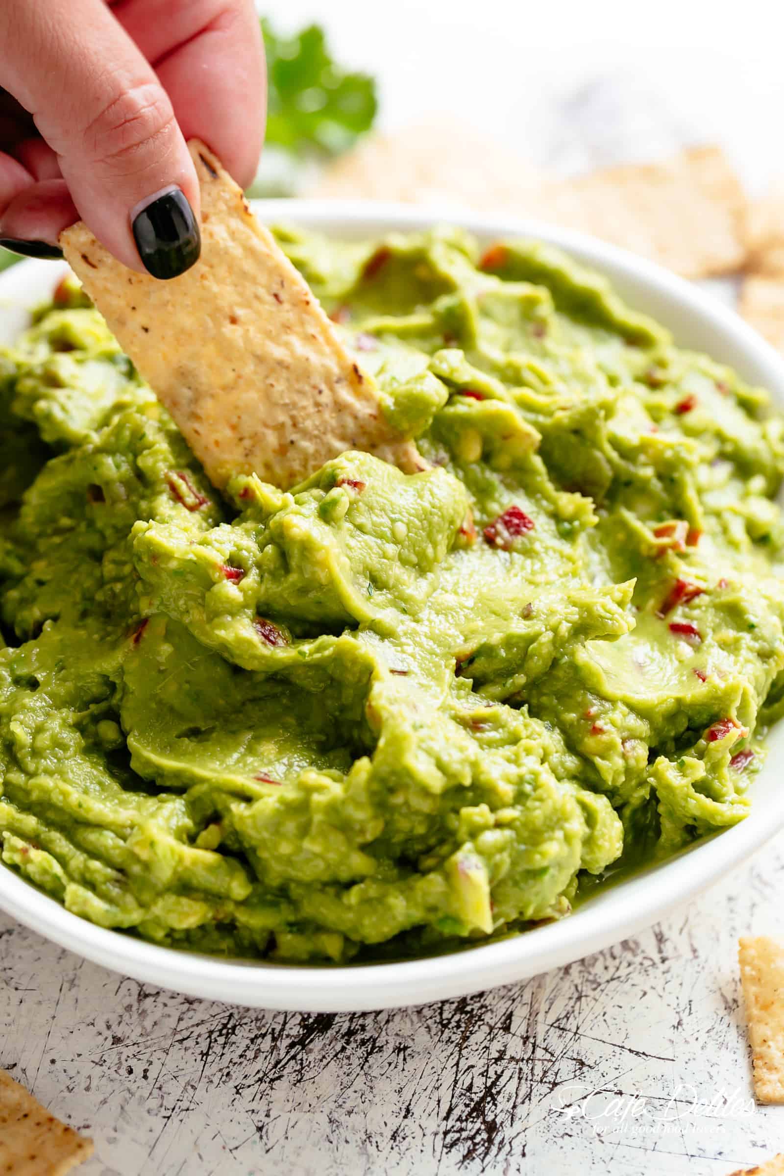 Homemade Guacamole for fajitas, tacos and carnitas in a white bowl