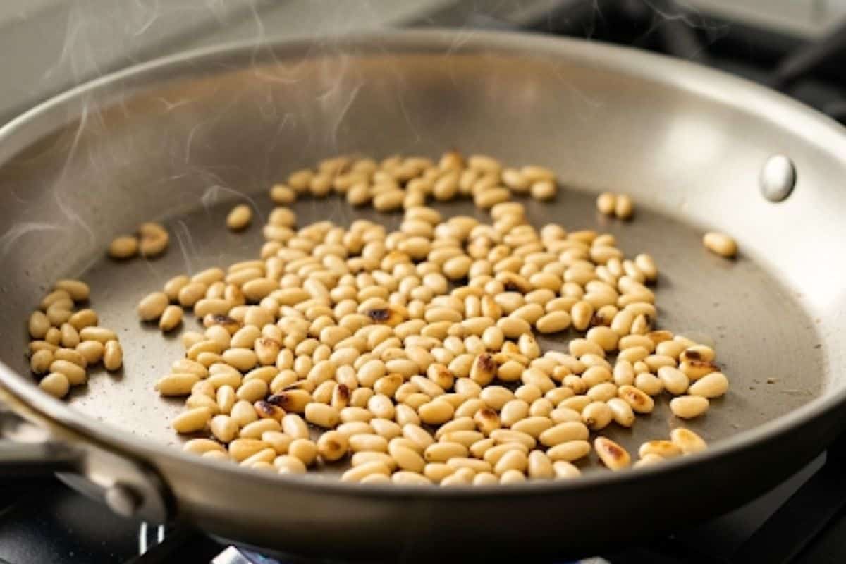 Toast the pine nuts until golden in a pan.