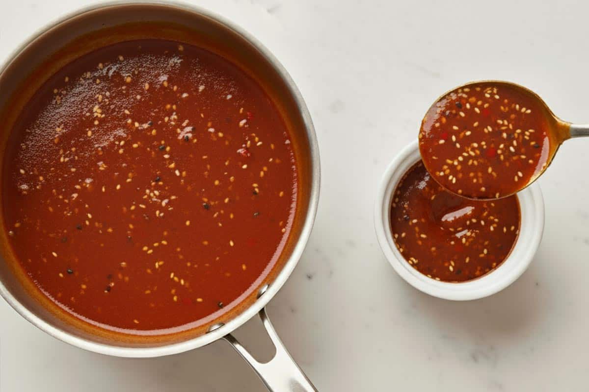 Transferring some of the sauce to a small dish.