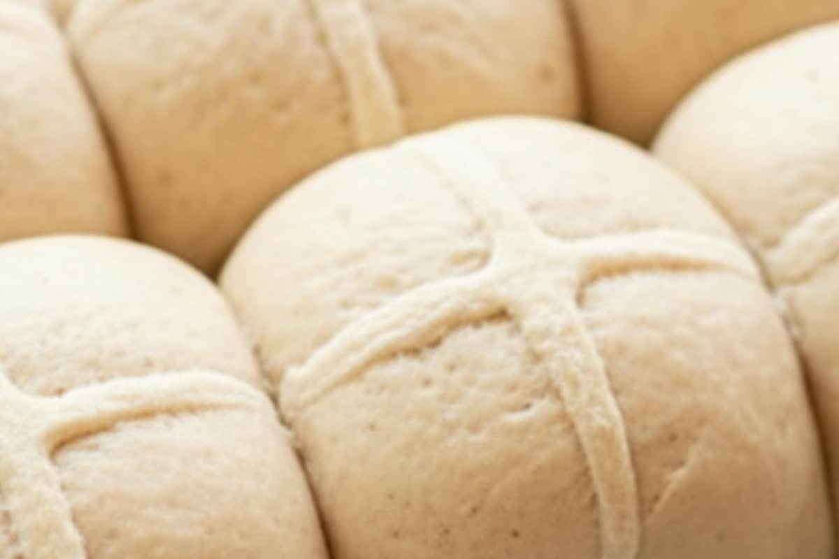 Mix flour and warm water to form a thick paste. Spoon into a ziplock bag, snip the corner, and pipe crosses over the buns.